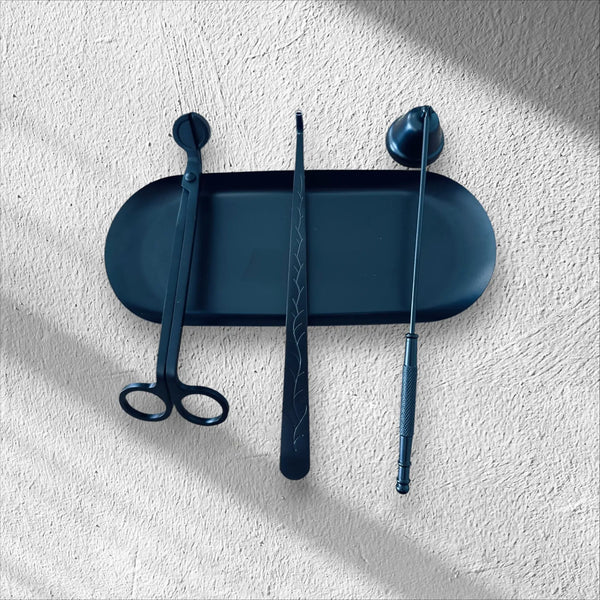 A black Candle Care kit with wick trimmer, snuffer and dipper and tray to put them on