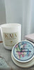 KAIA Fragrances candle and a small container with a decorative label on a light background