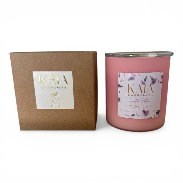 Pink Mother's Day candle with floral label and brown box labeled 'KAIA' on a white background