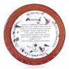 Round container with floral design and warning label on a white background, featuring Kaia Fragrances branding.