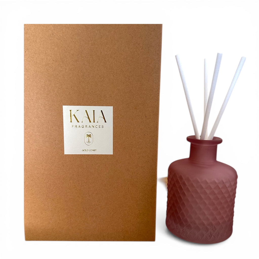 Pink textured diffuser bottle with sticks next to a Kraft brown box featuring 'KAIA' branding.