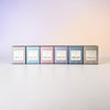Six boxes of KAIA Fragrances coco soy candles from the State Collection on a gradient background