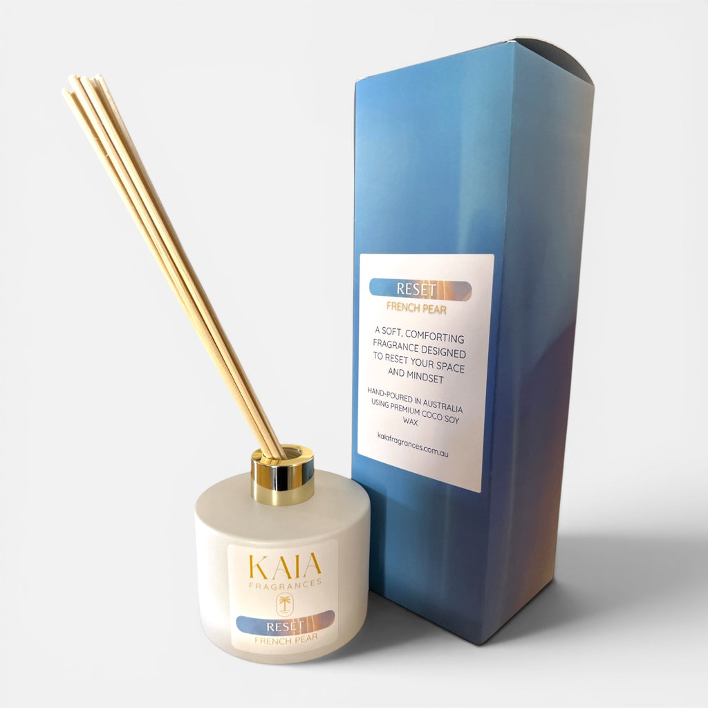 KAIA diffuser with gold sticks and blue packaging on a white background