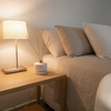 KAIA Relax Diffuser in Bedroom scene with a bed, nightstand, and lamp.