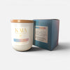 KAIA Fragrances candle with coconut and lime scent next to its packaging on a white background