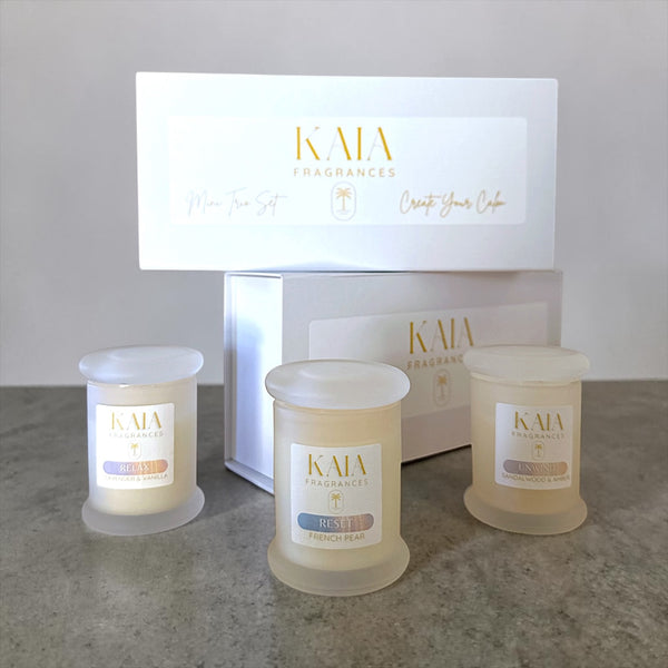 Three Kaia Fragrances candles with a branded box in the background.