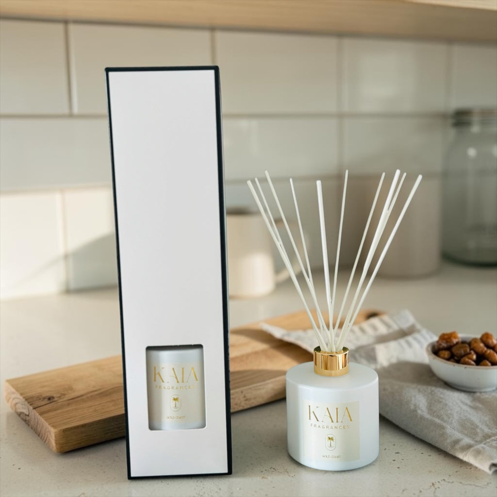 White diffuser with gold cap and 'KAIA' branding on a kitchen counter.